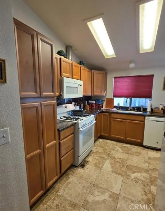 27250 Murrieta Road, Unit 390 Menifee, CA 92586 - Photo 12 of 30 a kitchen with stainless steel appliances a refrigerator sink and microwave