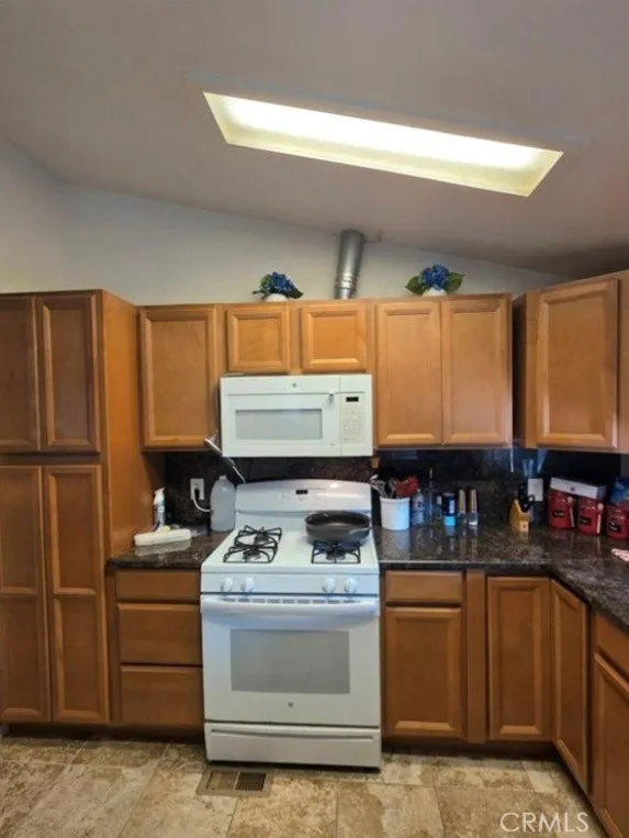 27250 Murrieta Road, Unit 390 Menifee, CA 92586 - Photo 14 of 30 a kitchen with appliances a sink and cabinets