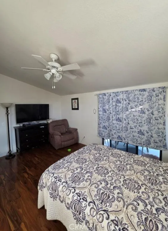 27250 Murrieta Road, Unit 390 Menifee, CA 92586 - Photo 21 of 30 a bedroom with a bed and a television