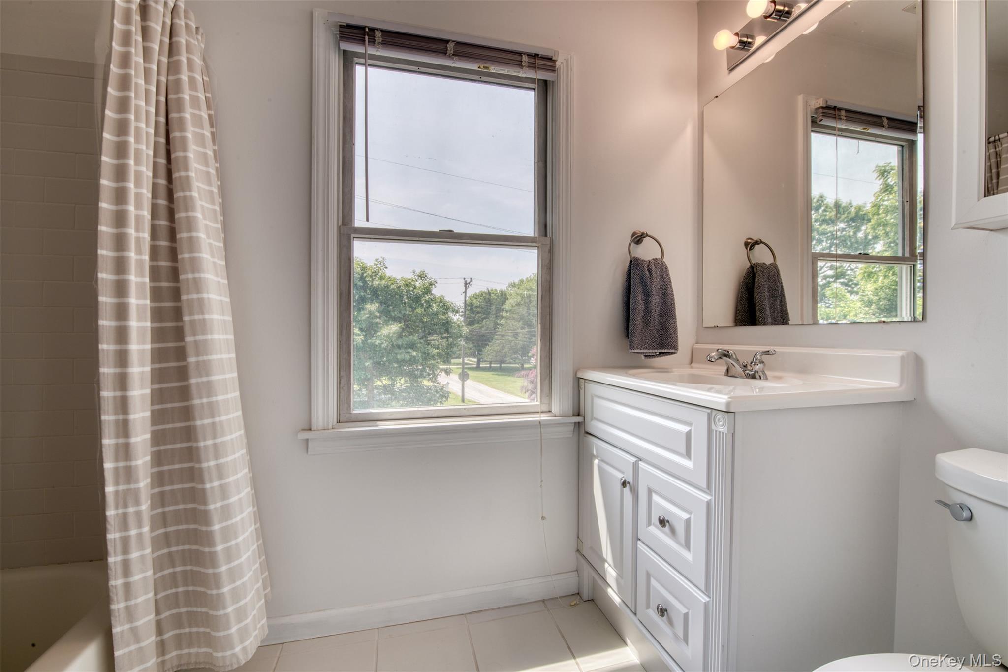 39595 Main Road Orient, NY 11957 - Photo 12 of 15 a bathroom with a sink a toilet and a mirror