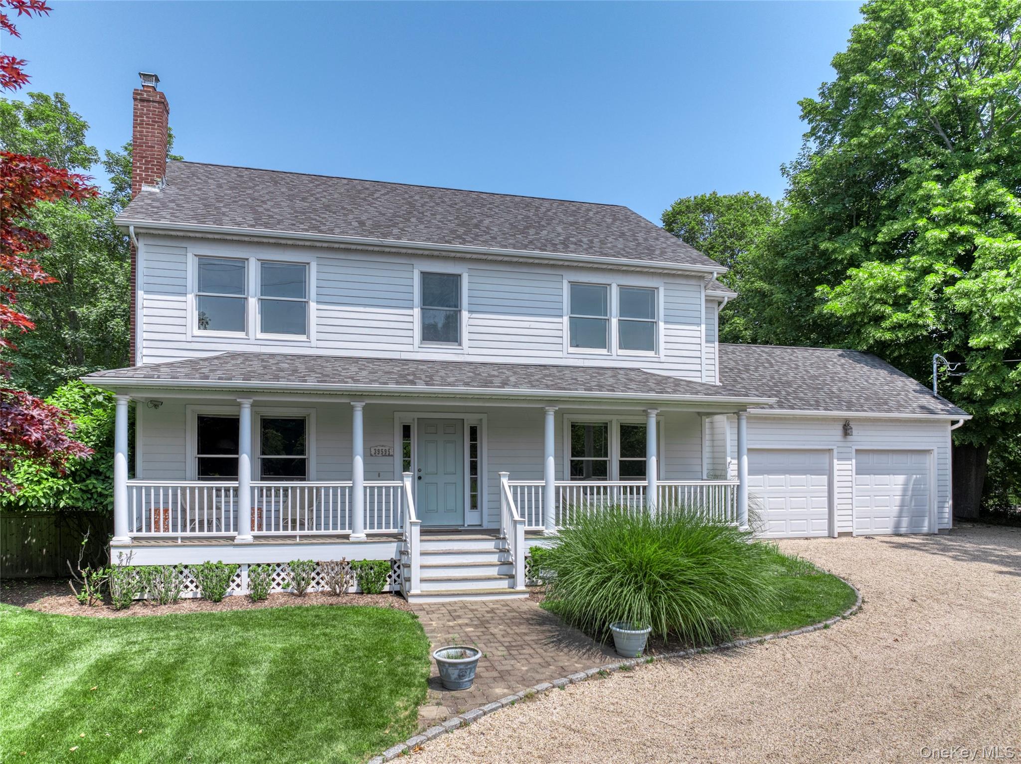 39595 Main Road Orient, NY 11957 - Photo 15 of 15 a front view of a house with a yard and garage