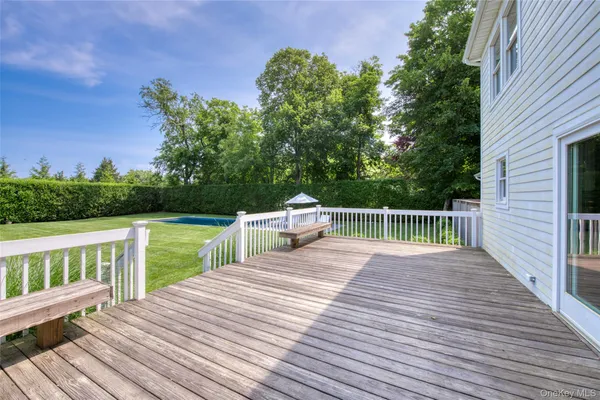 a balcony with wooden floor and fence