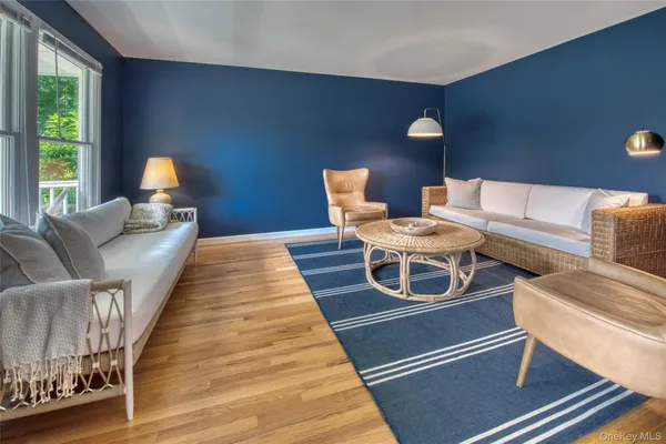 a living room with furniture and a lamp