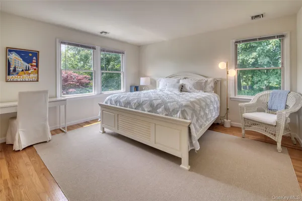 a spacious bedroom with a bed couch and a window