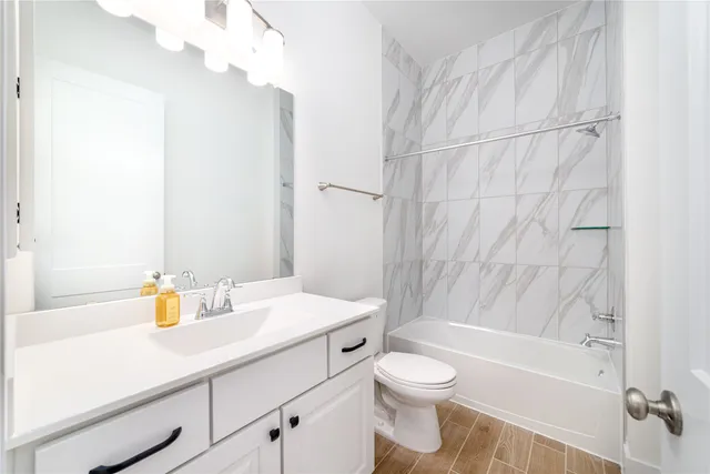 a bathroom with a sink a toilet and shower