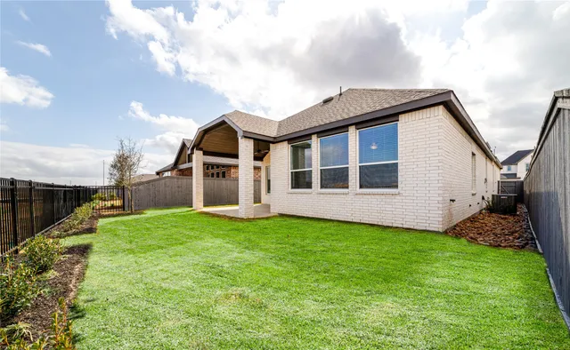 a front view of a house with a garden and yard