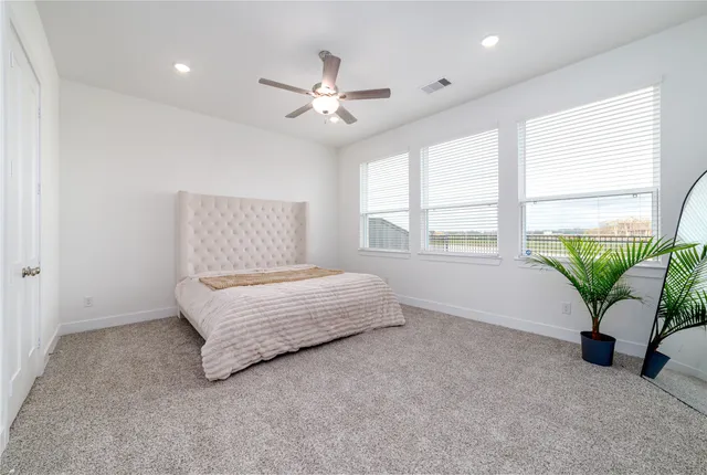 a living room with furniture and potted plant