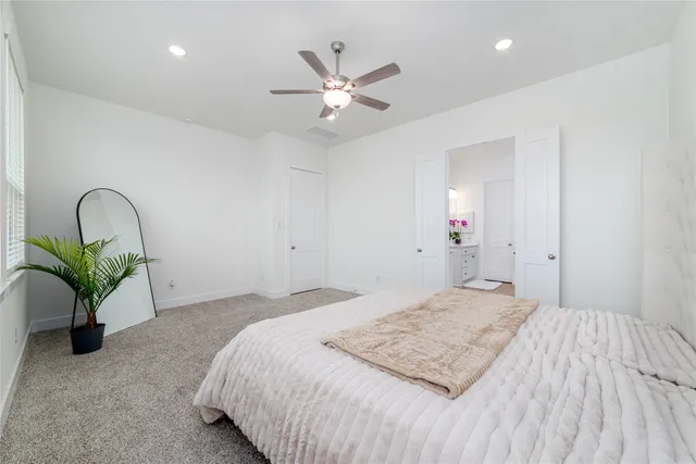 a bedroom that has a bed and a chandelier