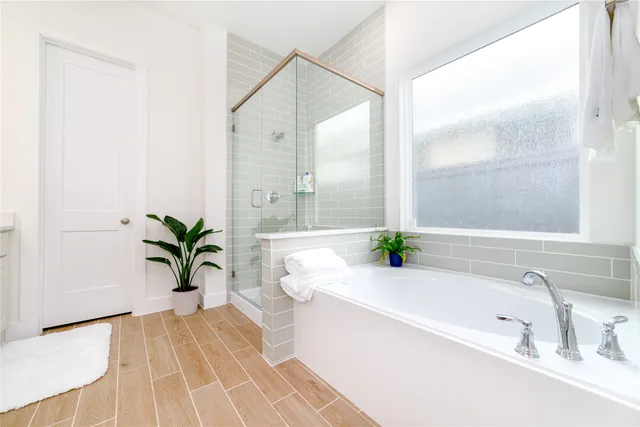 a bathroom with a bathtub a sink and a window