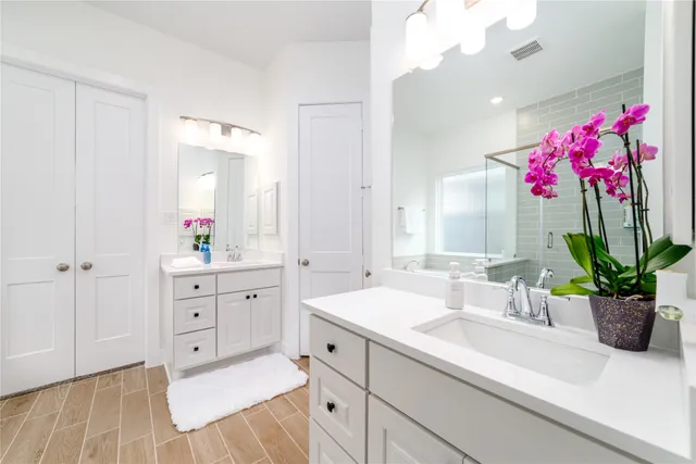 a spacious bathroom with a sink mirror and vanity