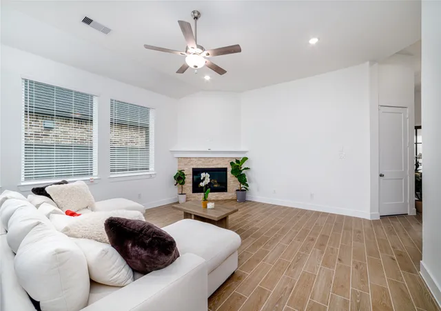 a living room with furniture and a fireplace