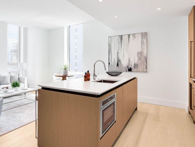 a kitchen with stainless steel appliances granite countertop a sink and a granite counter tops with a large window