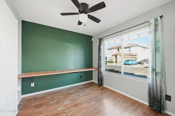 a view of a hallway with wooden floor and a chandelier