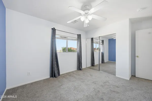 an empty room with windows and entrance