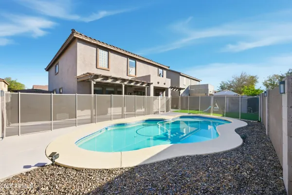 a view of a pool in front of the house