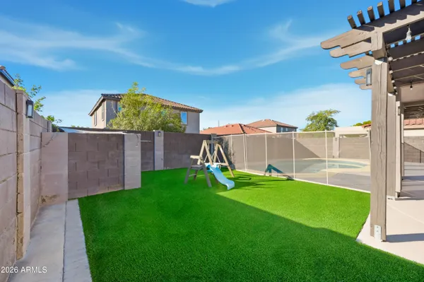 a view of a house with backyard and sitting area