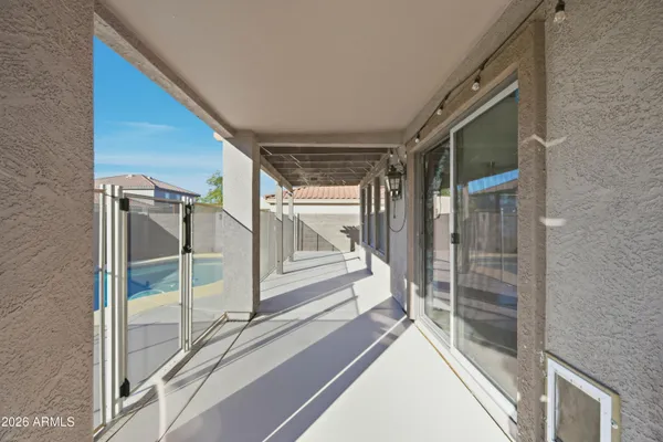 a backyard of a house with table and chairs