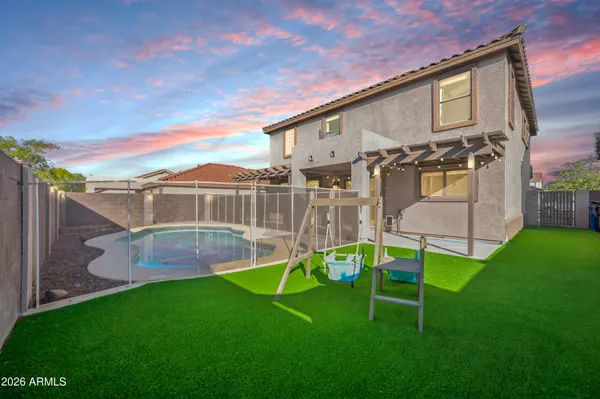a view of a house with swimming pool and a yard