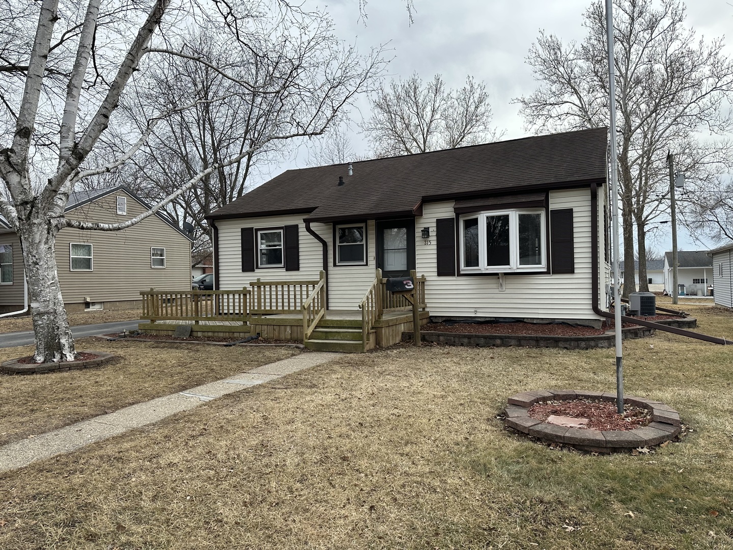a backyard of a house with oven and a tree