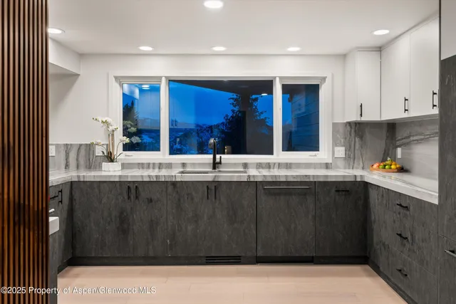 a living room with furniture and large windows