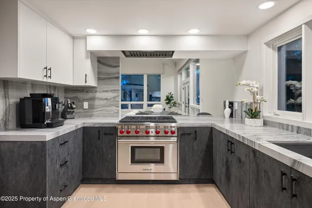 a living room with furniture and large windows