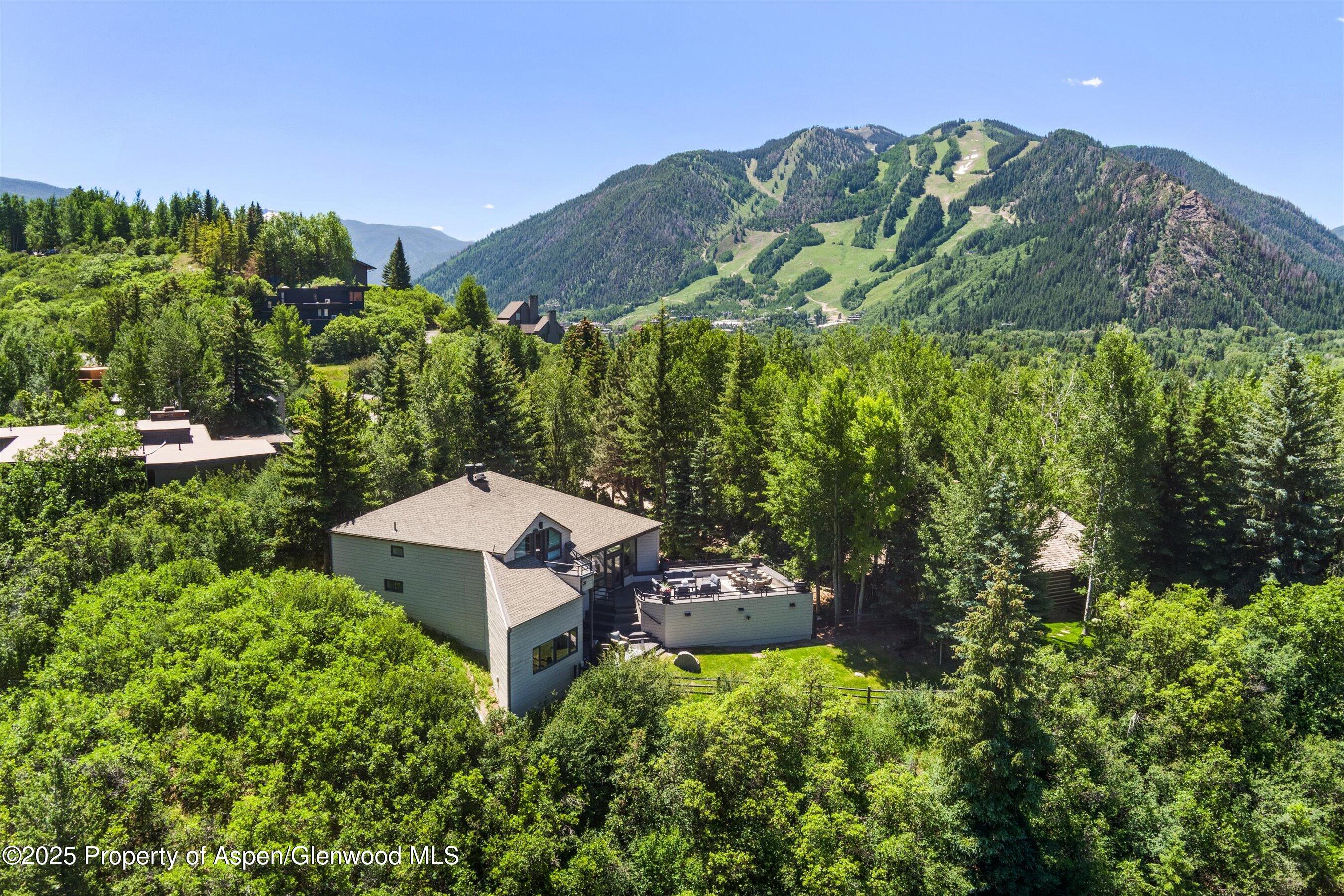 75 Bennett Court Aspen, CO 81611 - Photo 2 of 65 a backyard of a house with a yard and outdoor seating