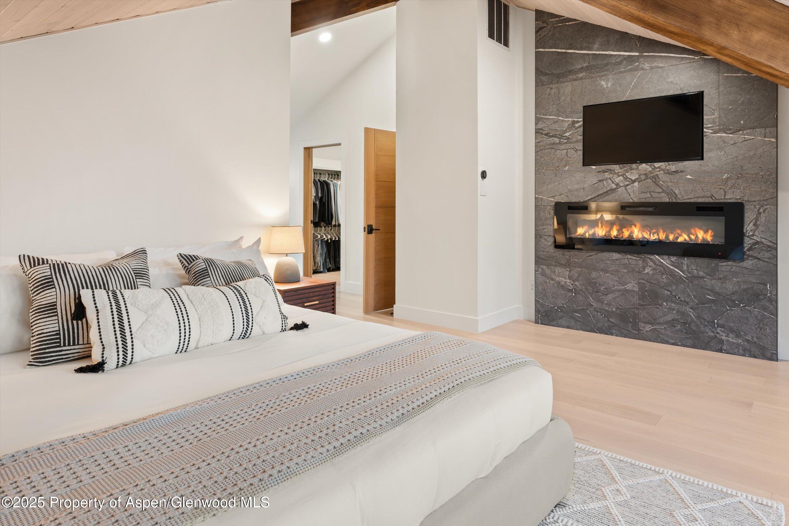 75 Bennett Court Aspen, CO 81611 - Photo 22 of 65 a bedroom with a bed and a flat screen tv
