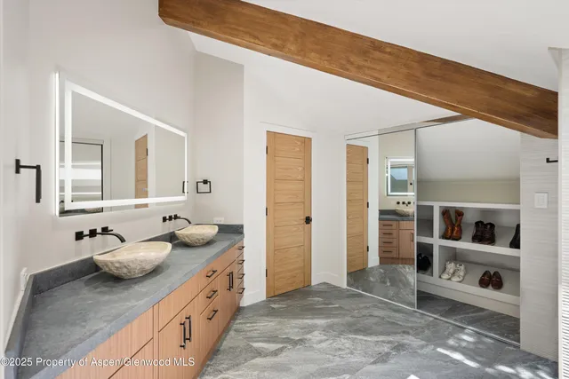 a bathroom with a granite countertop sink a toilet and a mirror