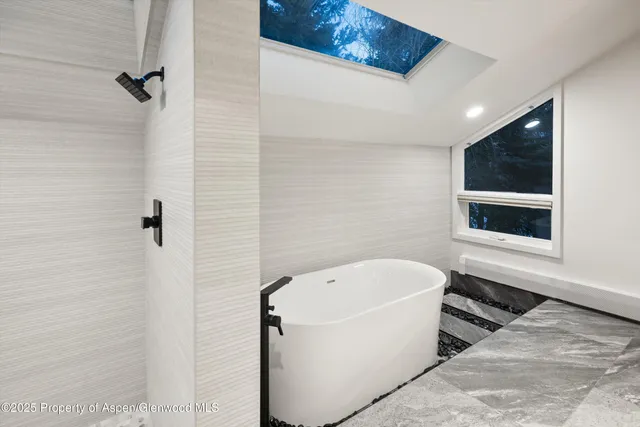 a view of a balcony with two chairs and a potted plant