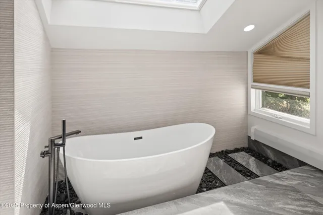 a balcony with wooden floor and outdoor seating