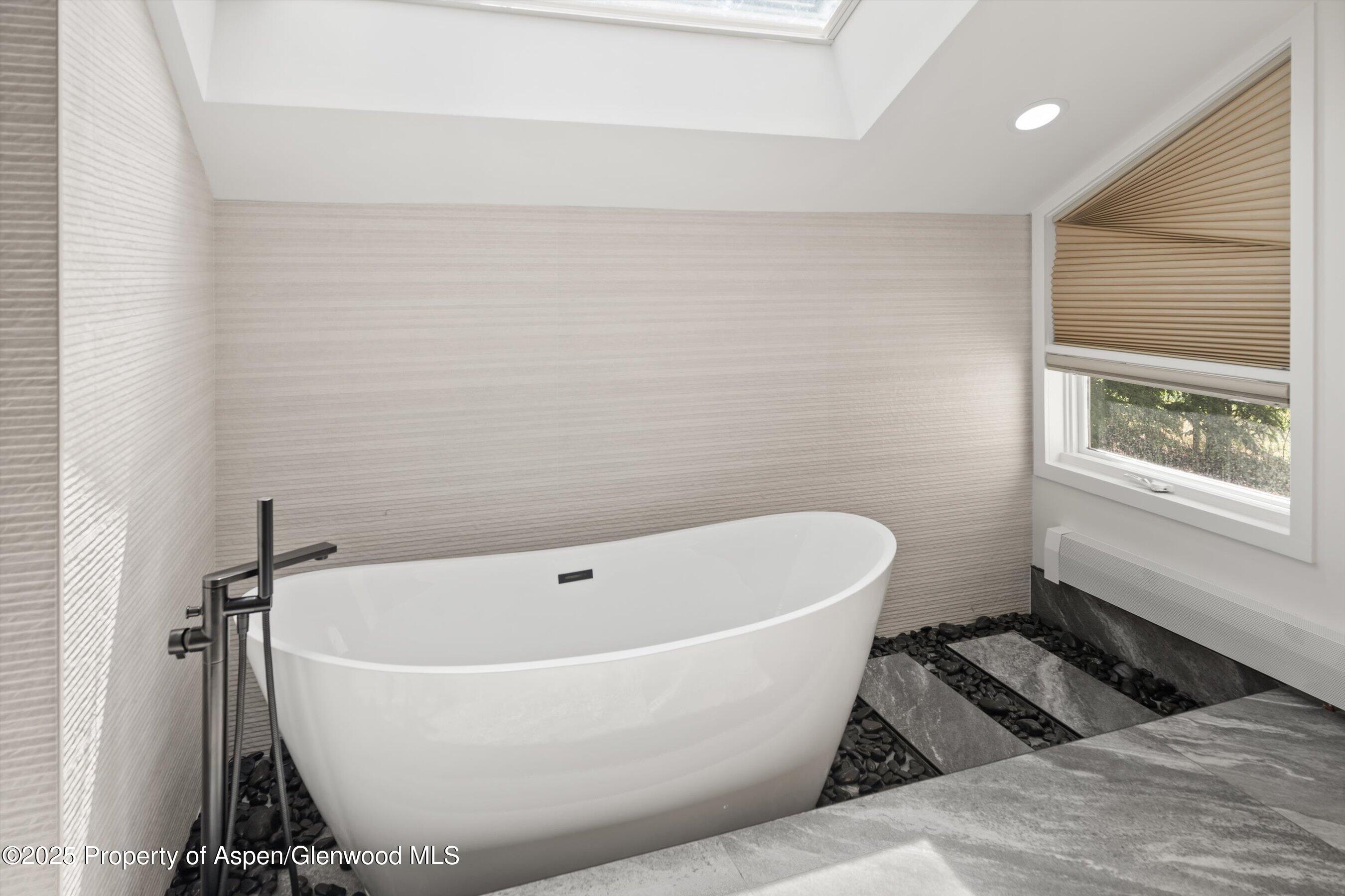 75 Bennett Court Aspen, CO 81611 - Photo 30 of 65 a bathroom with a bathtub and window