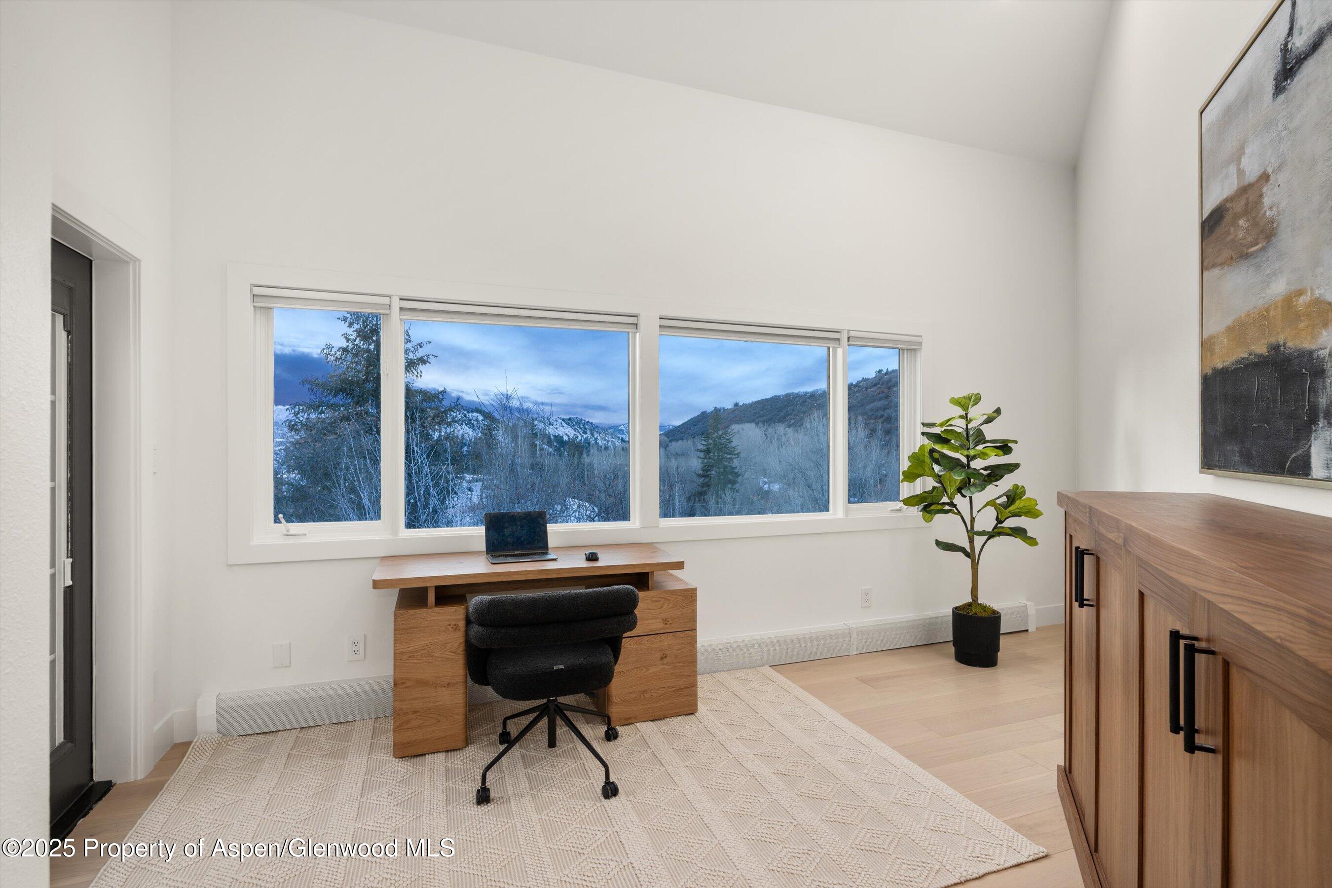 75 Bennett Court Aspen, CO 81611 - Photo 35 of 65 a workspace with furniture and a window