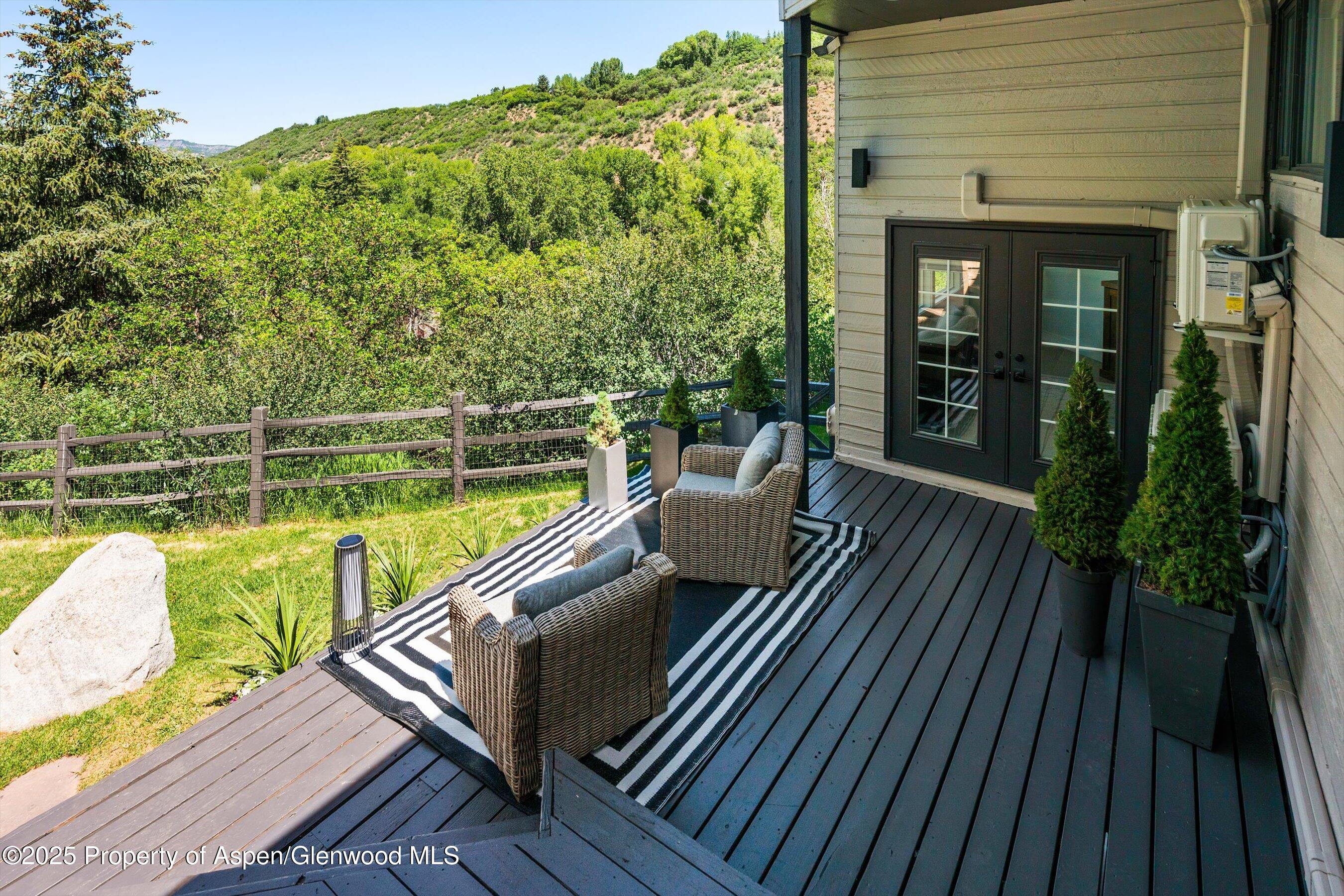 75 Bennett Court Aspen, CO 81611 - Photo 38 of 65 a view of a balcony with two chairs and a potted plant
