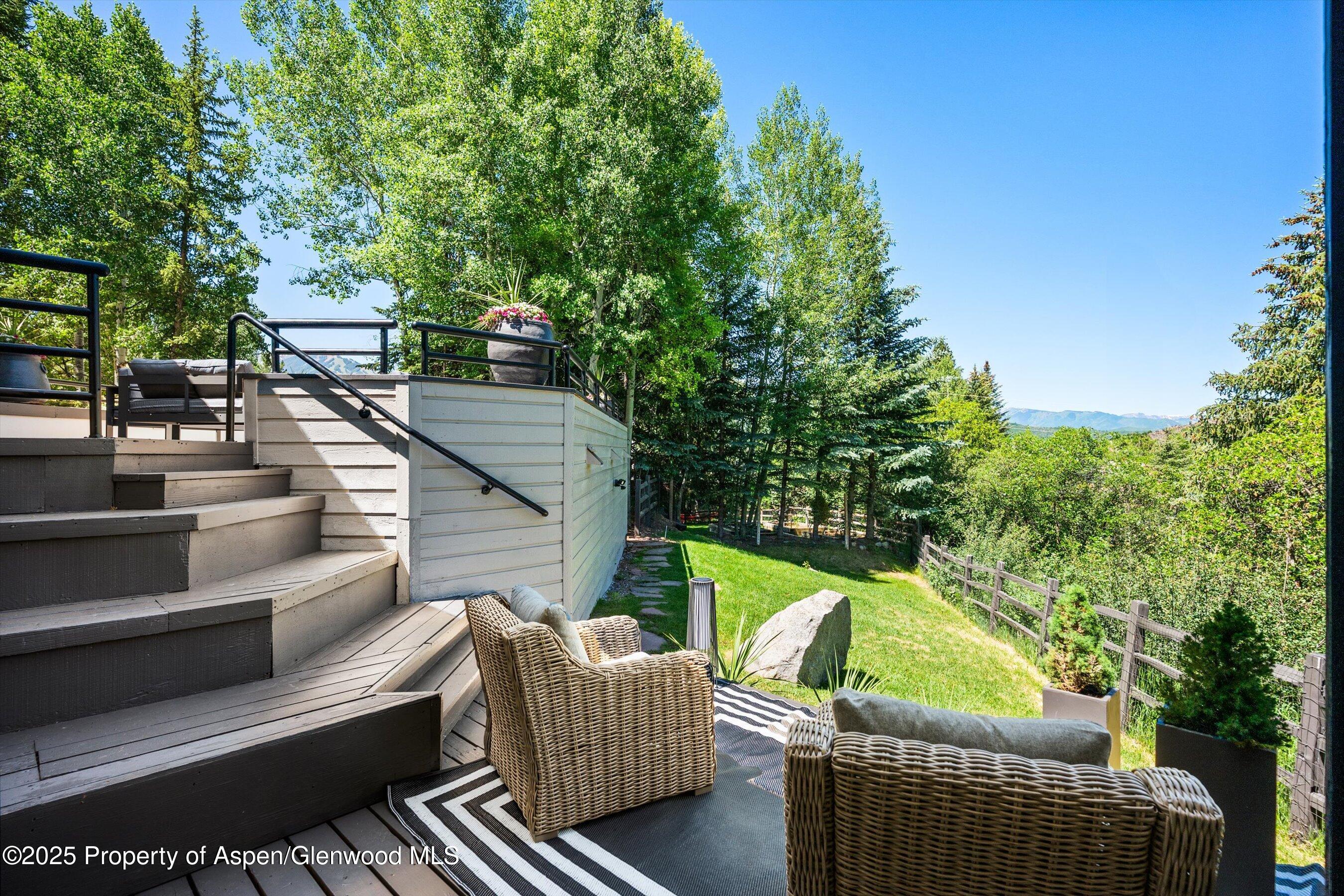 75 Bennett Court Aspen, CO 81611 - Photo 39 of 65 a balcony with wooden floor and outdoor seating