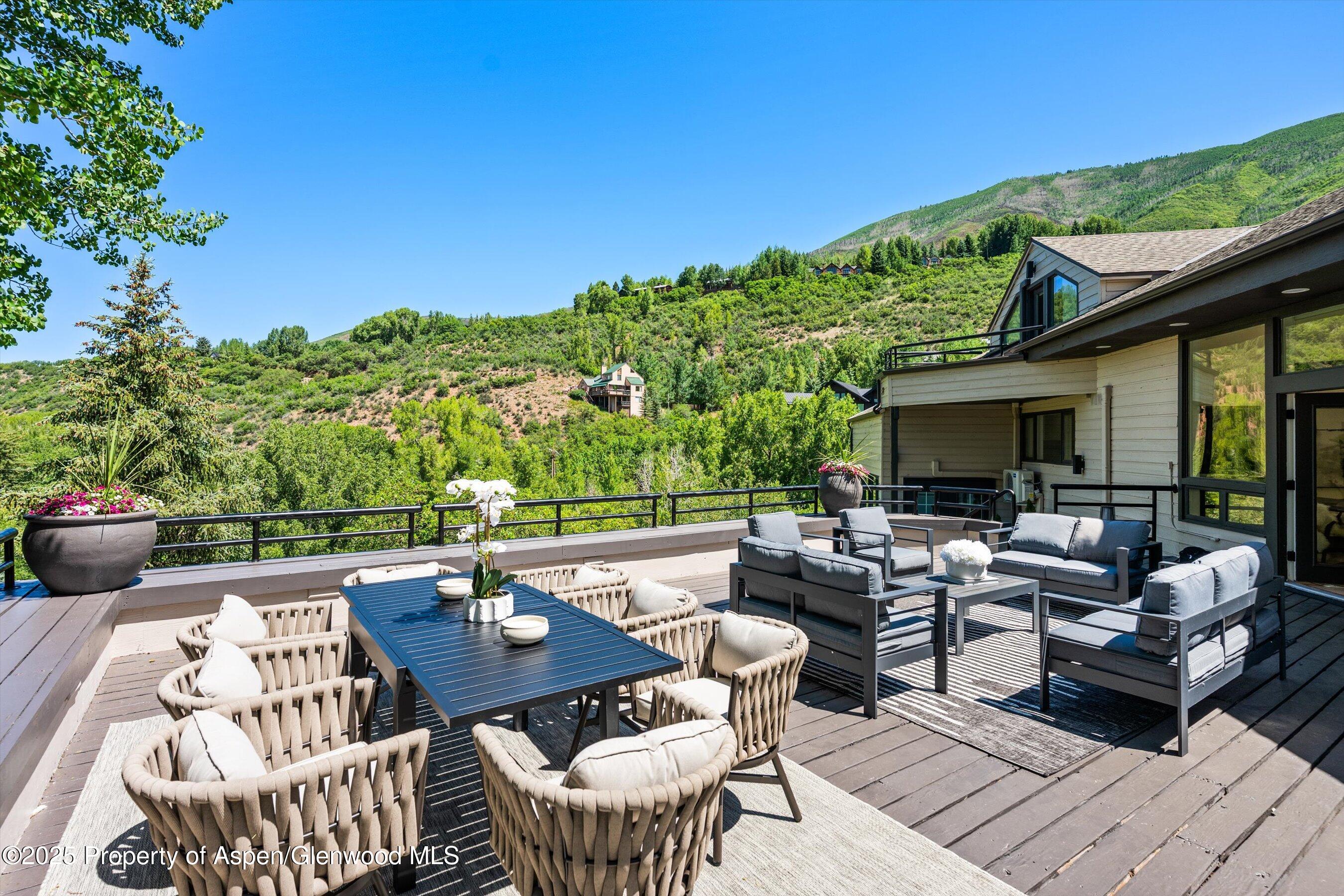 75 Bennett Court Aspen, CO 81611 - Photo 40 of 65 a view of a patio with couches potted plants and outdoor seating