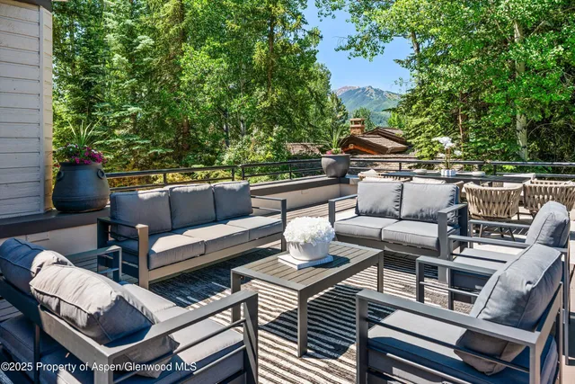 a view of a house with a mountain and a forest