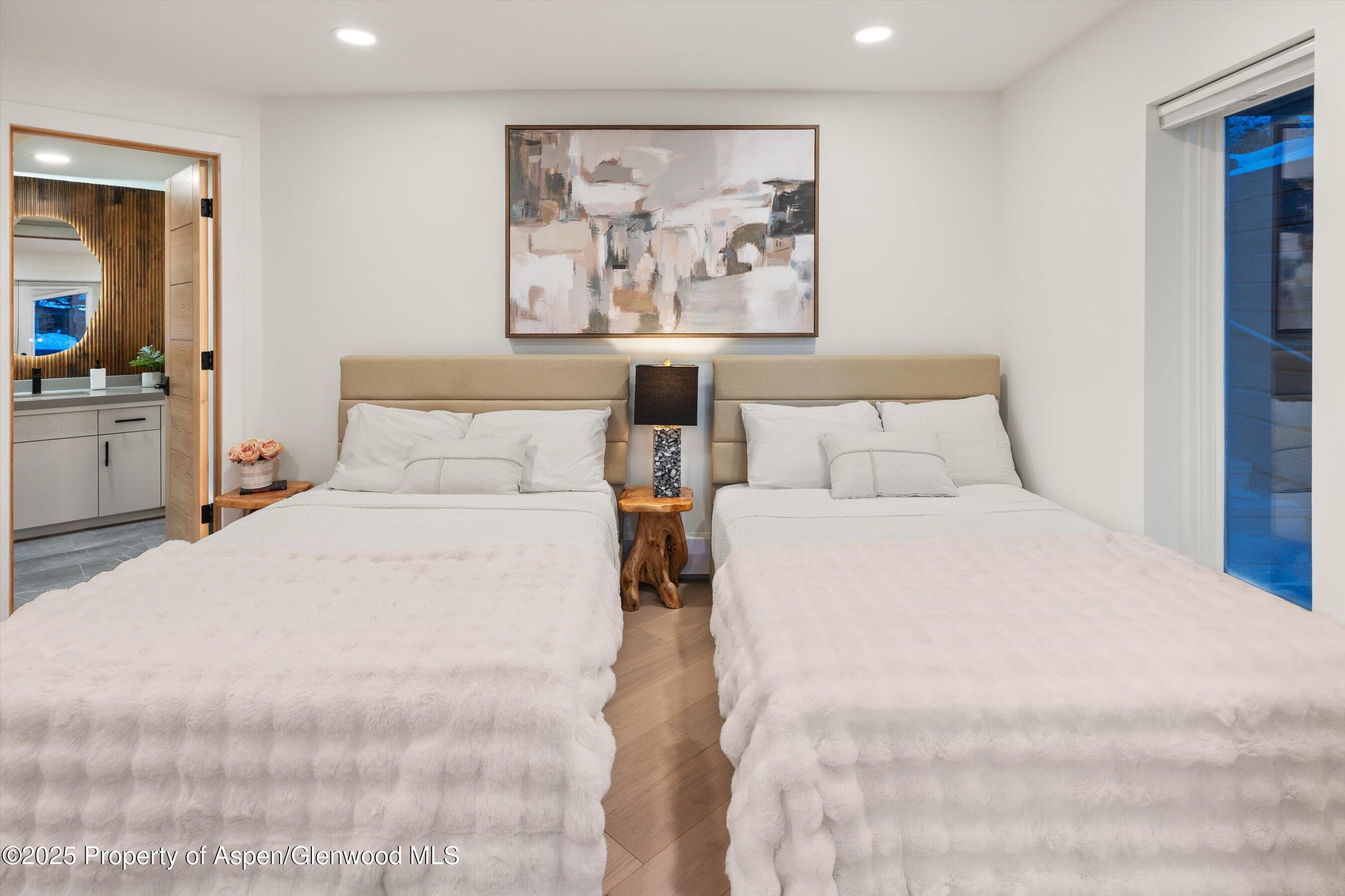 75 Bennett Court Aspen, CO 81611 - Photo 52 of 65 a bedroom with a large bed and a painting on the wall