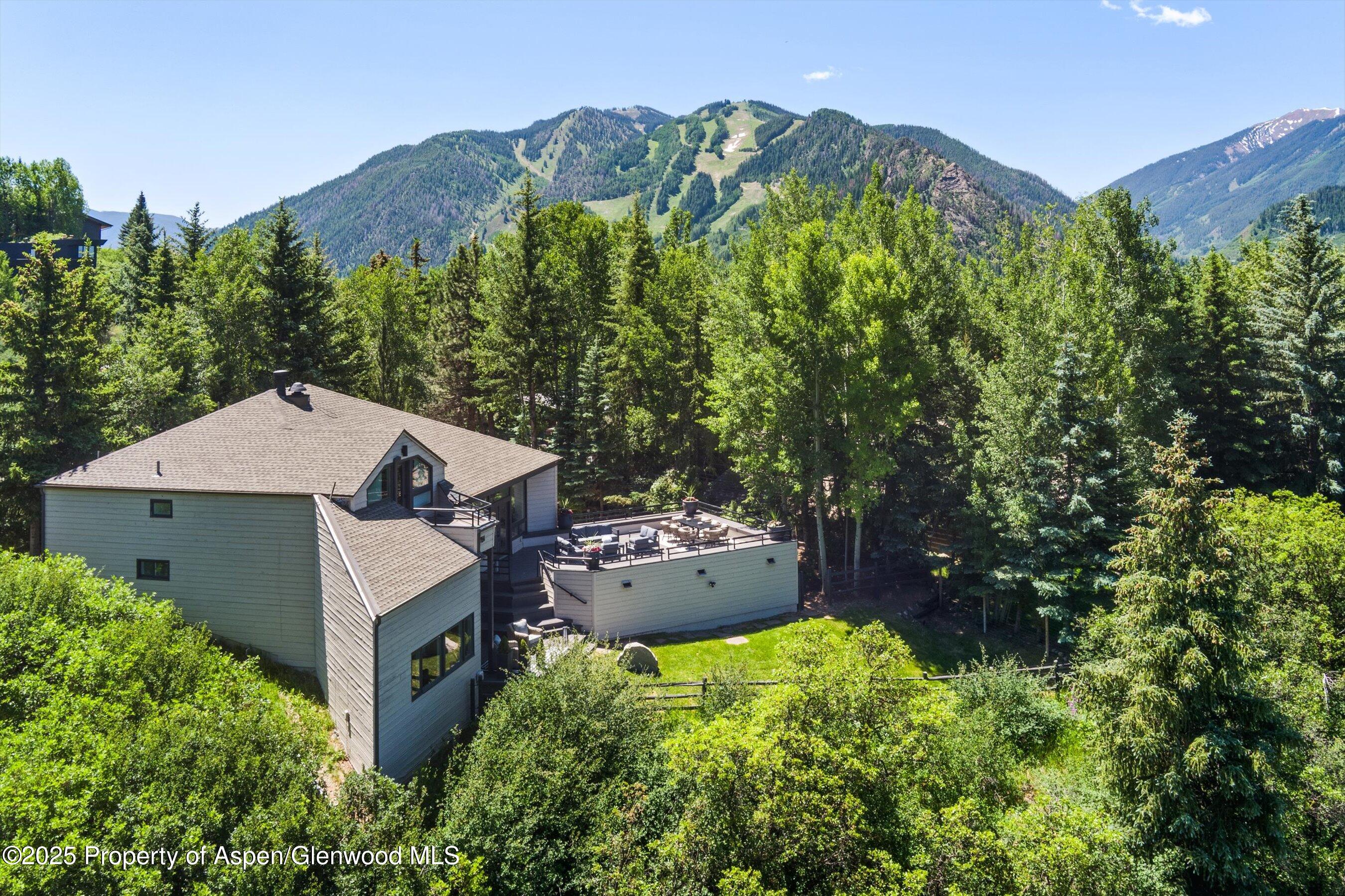 75 Bennett Court Aspen, CO 81611 - Photo 57 of 65 an aerial view of a house with yard and outdoor seating