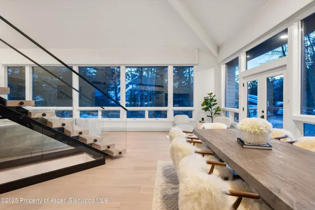 a living room with furniture and large windows