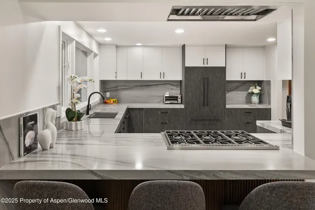a kitchen with stainless steel appliances granite countertop a stove and a sink