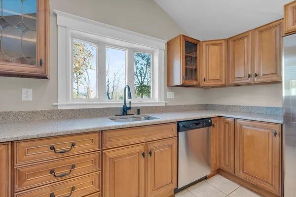 a kitchen with granite countertop white cabinets and white appliances