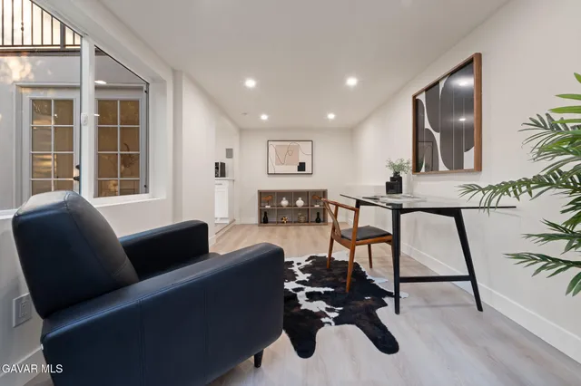a living room with furniture and large windows