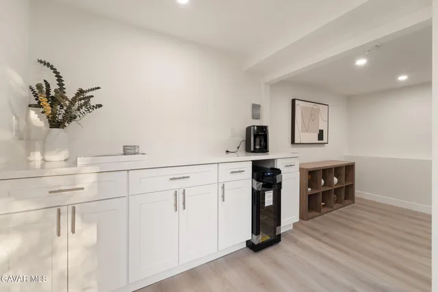 a kitchen with a refrigerator and a sink