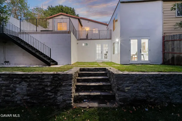 a view of a house with a small yard