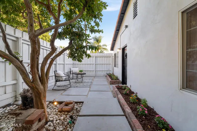 a view of a backyard with sitting area