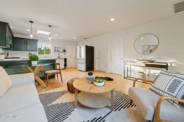 a living room with furniture kitchen view and a table