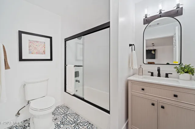 a bathroom with a toilet sink and shower