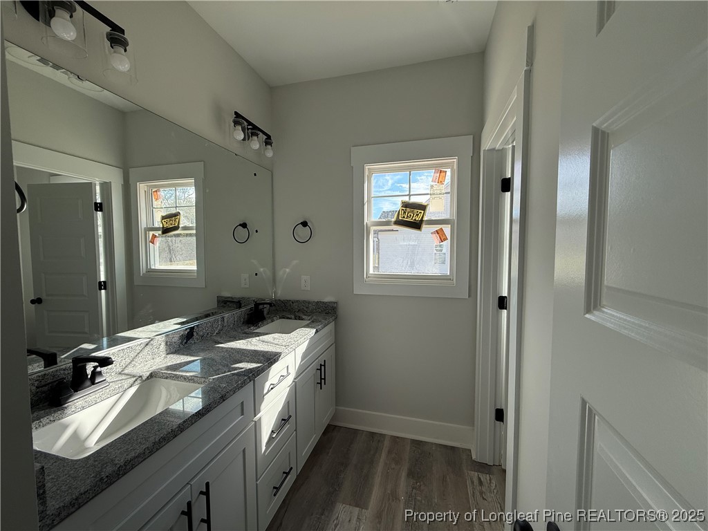 7166 Chicken Foot Road St. Pauls, NC 28384 - Photo 4 of 13 a bathroom with a granite countertop sink and a mirror