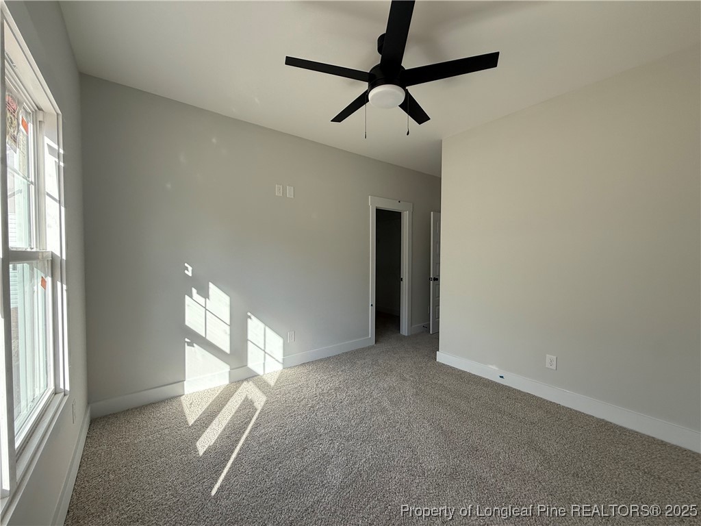 7166 Chicken Foot Road St. Pauls, NC 28384 - Photo 8 of 13 a view of a livingroom with a ceiling fan and window