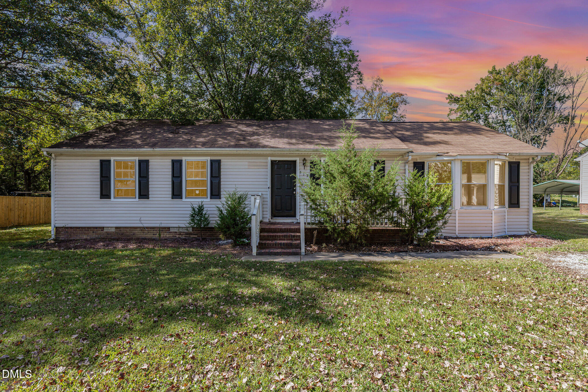 a view of a house with a yard and plants
